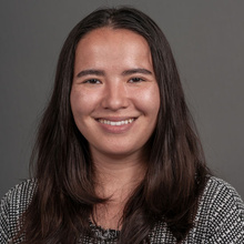 Anna Roskamp, smiling against a gray backdrop.