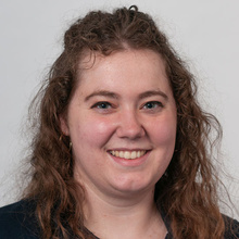Sarah Wright, smiling against a white backdrop.