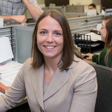 Alison Guernsey headshot, wearing beige blazer and sitting in clinic office in Boyd Law Building