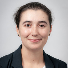 Madeleine Breunig smiles for a professional photo against a light gray backdrop.