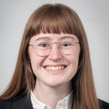 Emma Diers smiles for a professional photo against a light gray backdrop.