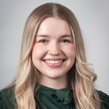 Veronica Miller smiles for a professional photo against a light gray backdrop.