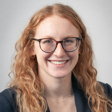 Maureen Wainwright smiles for a professional photo against a light gray backdrop.