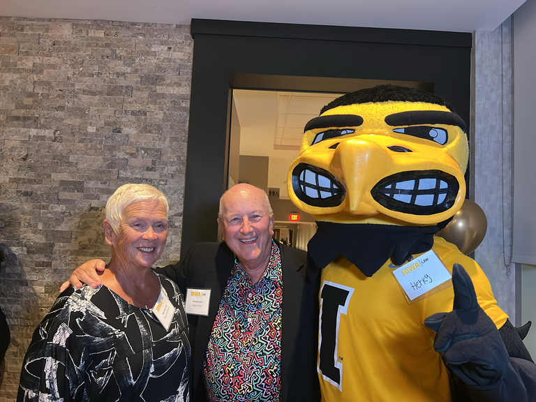 Alumni post with Herky the Hawk during Reunion weekend