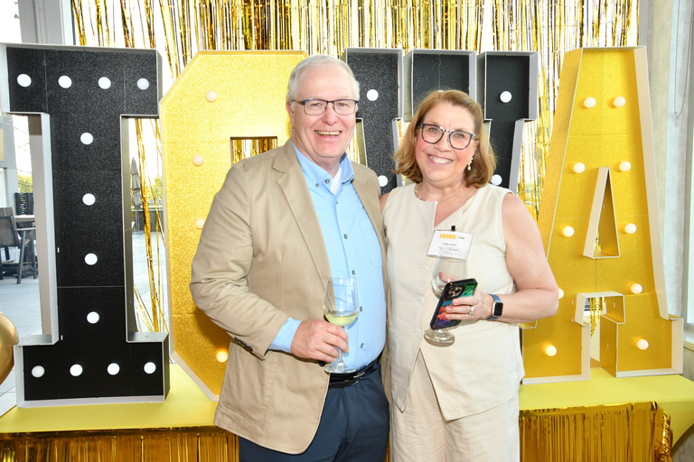 Alumni pose during a gathering at The Heights during Reunion weekend