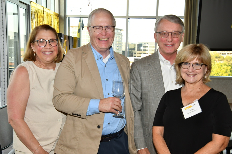 Attendees of a reunion weekend reception pause for a photo