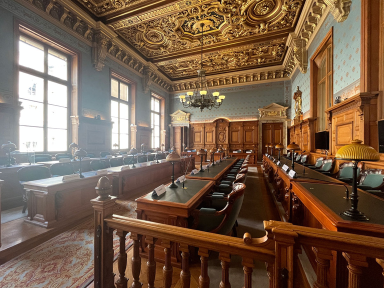 A photo of the interior of a courtroom in the Cour de Cassation.
