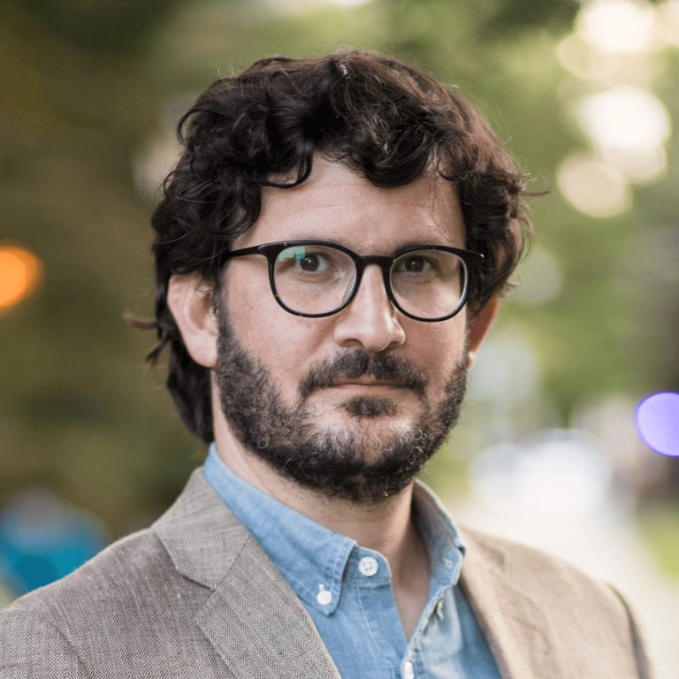 A headshot of Professor Andrew Jordan outdoors on a spring day.