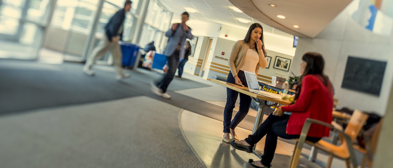 Students walking through the Student Experience Lobby in the Boyd Law Building 