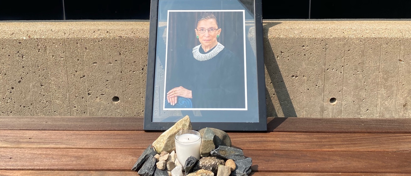 Memorial for Ruth Bader Ginsburg outside of the Boyd Law Building, including a framed photo of Ginsburg and a candle 