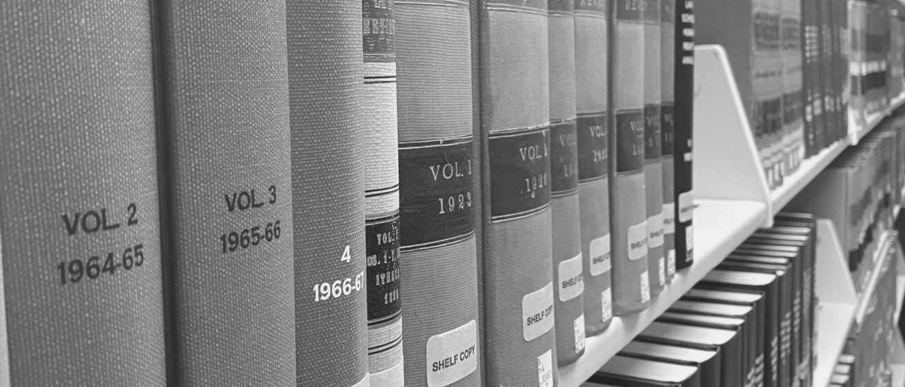 Black and white photo of books in the Iowa Law library 