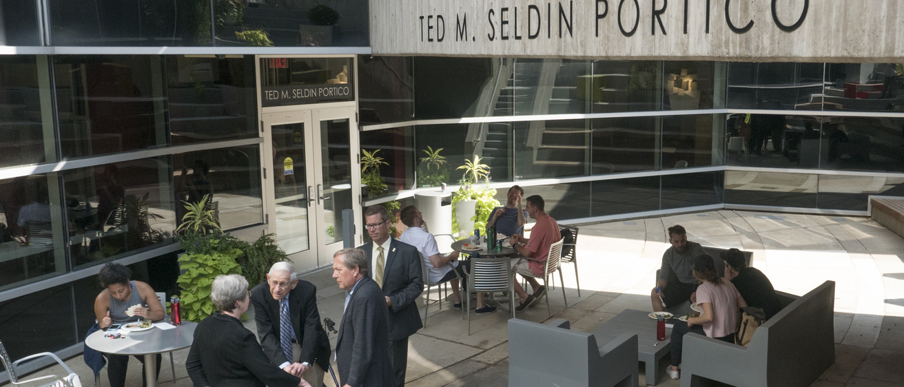 Ted Seldin and others at the Ted M. Seldin Portico outside of the Boyd Law Building