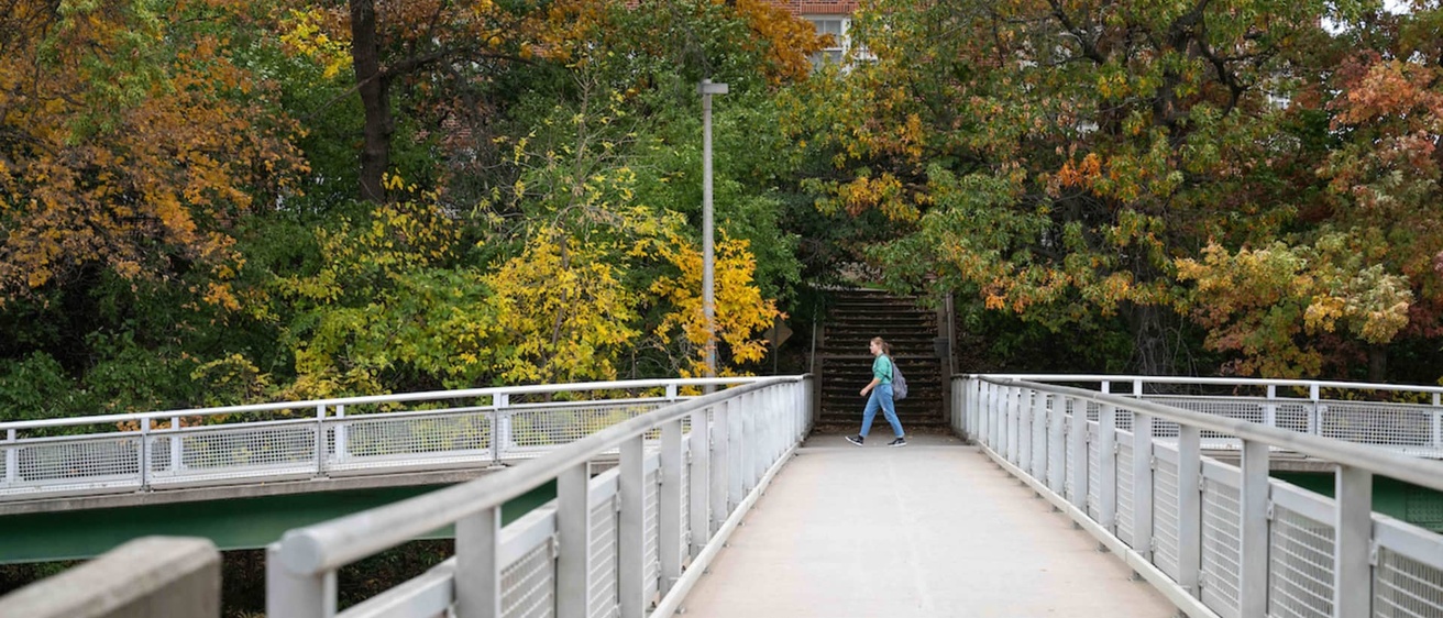 Students walks past the bridge leading to the back entrance of BLB in the fall. 