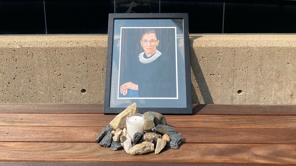Memorial for Ruth Bader Ginsburg outside of the Boyd Law Building, including a framed photo of Ginsburg and a candle 