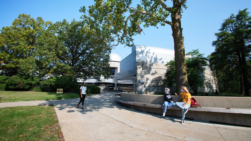 Masked Students outside of the Boyd Law Building on a sunny fall day