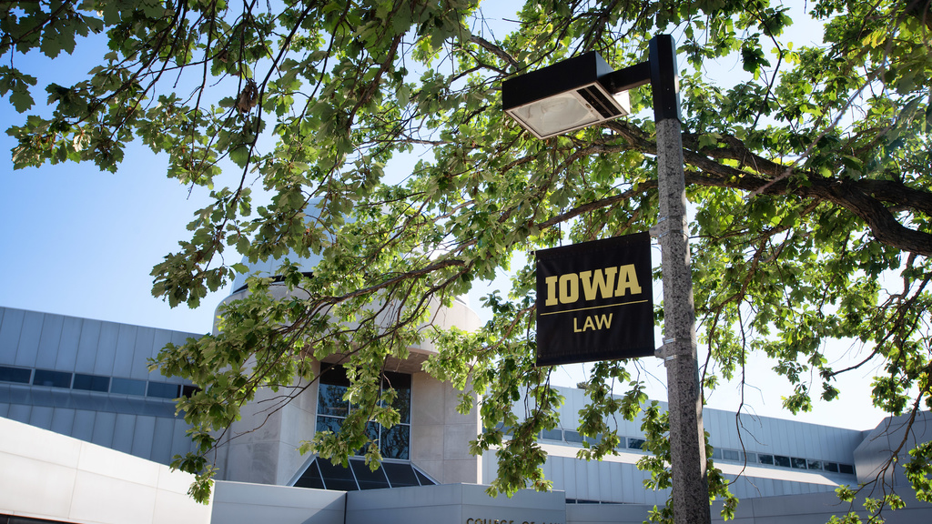 Outside of the Boyd Law Building in summer with Iowa Law sign