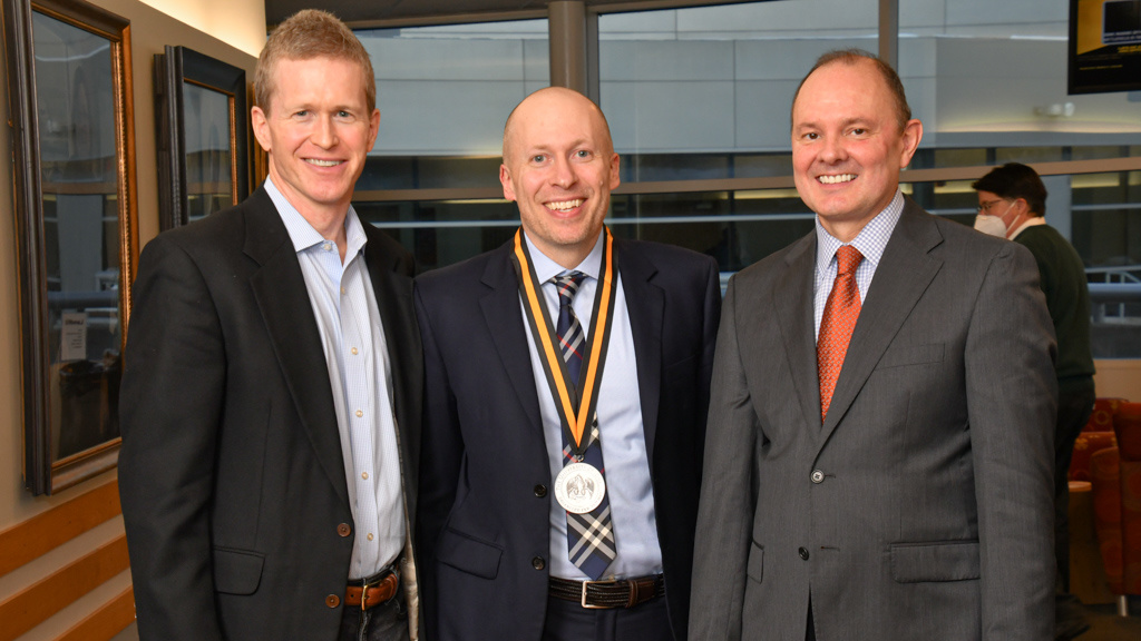 Professors Pettys and Yockey with Dean Washburn at Yockey's investiture ceremony