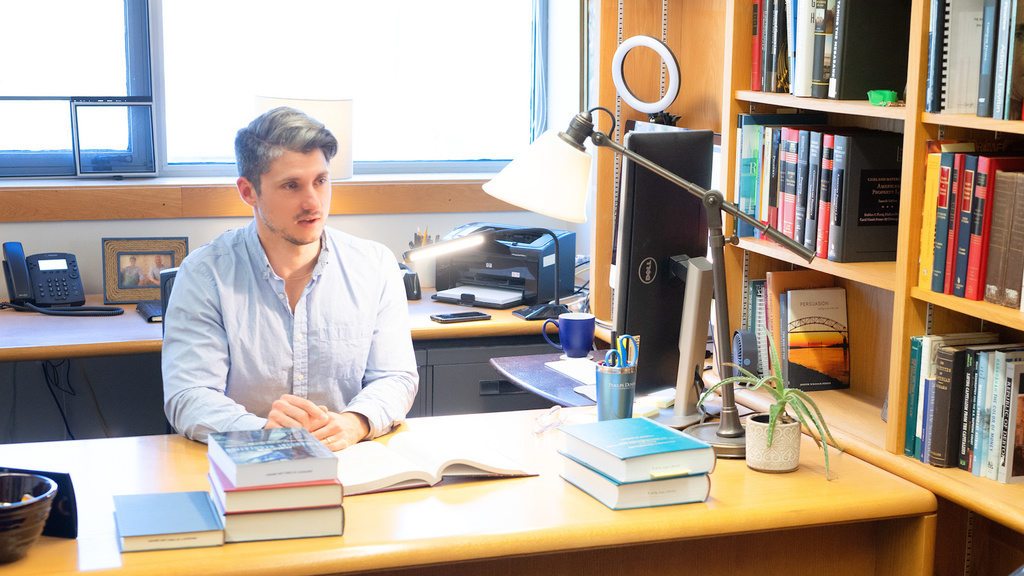 Professor Chris Odinet at his desk in BLB
