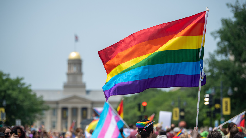 Pride flag waves at Pride Parade in front of the Old Capitol Building in Iowa City 2023