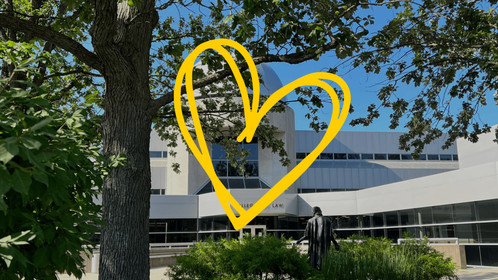 The Boyd Law Building on a sunny day with a yellow heart graphic overlayed on top for valentine's day. 