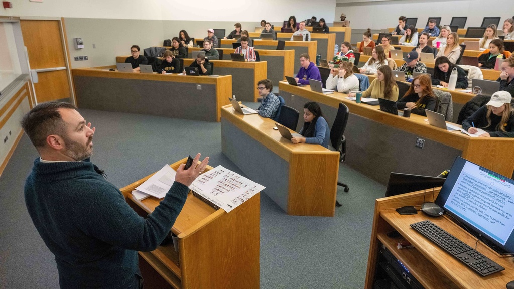 Professor Mihailis Diamantis lectures to law students in a large classroom. 