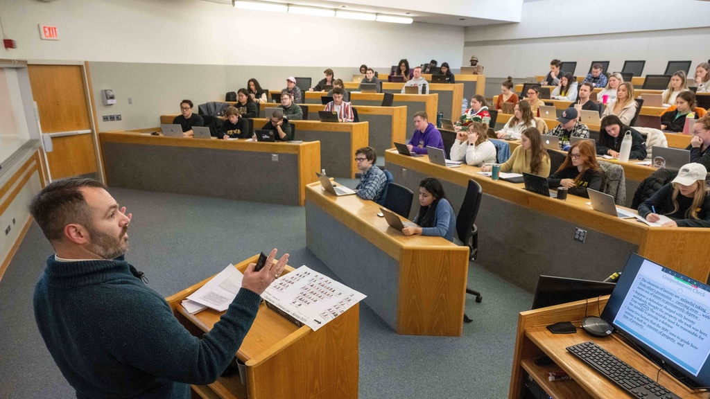 Professor Mihailis Diamantis lectures to law students in a large classroom. 